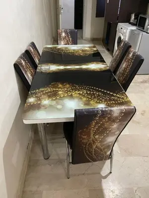 a table and chairs with gold lights on it at Appartement 16 2èm étage ( POUR FAMILLE ) in Marrakech