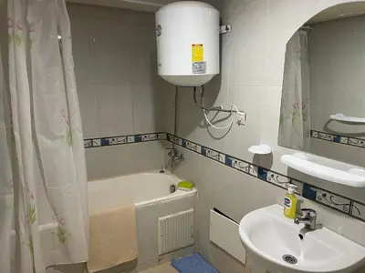 a bathroom with a sink and a bath tub at Appartement 16 2èm étage ( POUR FAMILLE ) in Marrakech