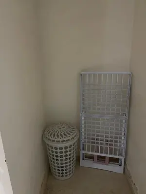 a corner of a room with a basket and a trash can at Appartement 16 2èm étage ( POUR FAMILLE ) in Marrakech