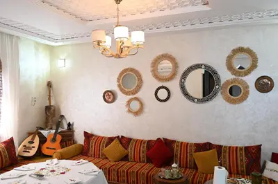 a living room with a couch and mirrors on the wall at Riad sarsar airport in Marrakech
