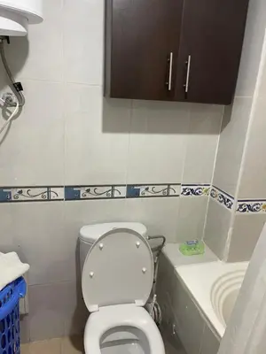 a small bathroom with a toilet and a sink at Appartement 18 3èm étage avec balcon ( POUR FAMILLE ) in Marrakech