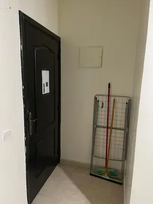 a black door with a cane next to a wall at Appartement 18 3èm étage avec balcon ( POUR FAMILLE ) in Marrakech