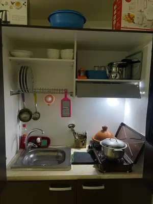 a kitchen with a sink and a stove with a pot at Appartement 19 3èm étage ( POUR FAMILLE ) in Marrakech