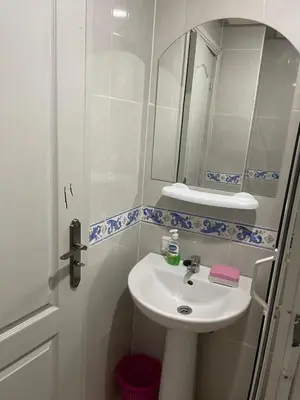 a bathroom with a sink and a mirror at Appartement 19 3èm étage ( POUR FAMILLE ) in Marrakech