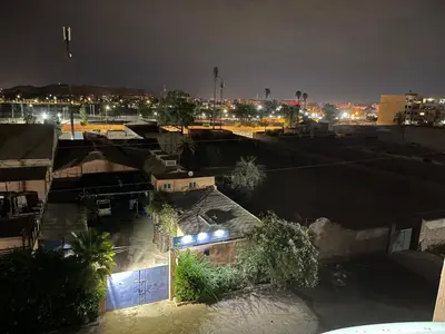 a view of a city at night with lights at Appartement 20 3èm étage avec balcon ( POUR FAMILLE ) in Marrakech