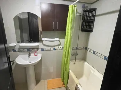 a bathroom with a sink and a tub and a toilet and a sink at Appartement 20 3èm étage avec balcon ( POUR FAMILLE ) in Marrakech