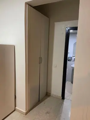 an empty room with a door and a bathroom at Appartement 22 au 3ème étage ( POUR FAMILLE ) in Marrakech