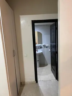 a bathroom with a toilet and a sink and a mirror at Appartement 22 au 3ème étage ( POUR FAMILLE ) in Marrakech