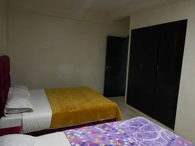 a small bedroom with two beds and a closet at Appartement 22 au 3ème étage ( POUR FAMILLE ) in Marrakech