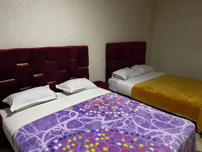 two beds sitting next to each other in a room at Appartement 22 au 3ème étage ( POUR FAMILLE ) in Marrakech