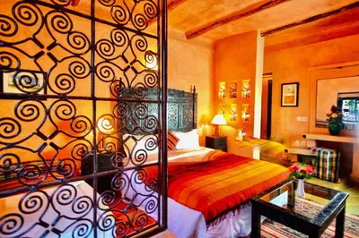 a bedroom with a bed with a red blanket at Jnane Leila in Marrakech