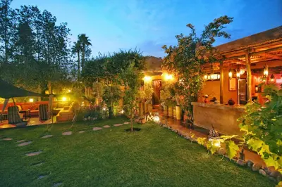 a backyard of a house at night with a garden at Jnane Leila in Marrakech