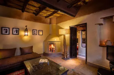 a living room with a couch and a fireplace at Jnane Leila in Marrakech