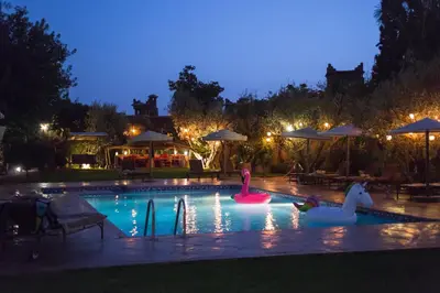 twolatable swans in a swimming pool at night at Jnane Leila in Marrakech