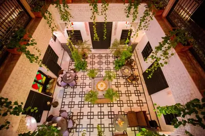 an overhead view of a floor with plants and a clock at Riad Ta'achchaqa in Marrakech