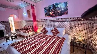 a bedroom with a bed and a couch at Riad Shaden in Marrakech