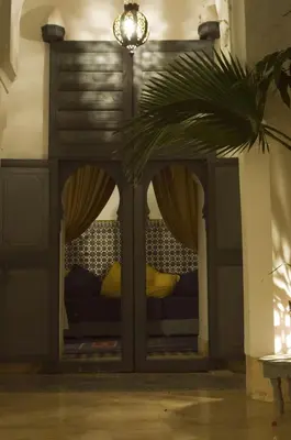 a couch in a room with a potted plant at Dar Touyir in Marrakech