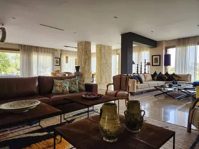 a large living room with couches and tables at Villa de rêve à Marrakech in Marrakech
