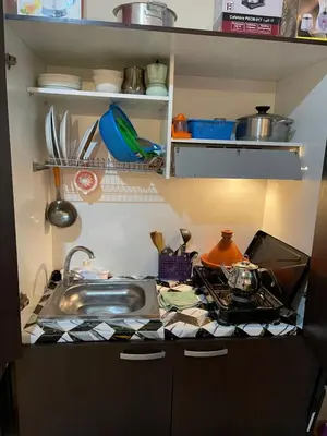 a kitchen with a sink and a counter top at Appartement 23 4èm étage avec balcon ( POUR FAMILLE ) in Marrakech