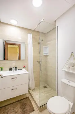 a bathroom with a shower and a toilet and a sink at Perle Rare a Prestigia - Vue Sur Golf in Marrakech