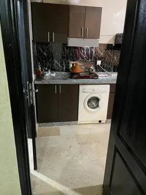 a kitchen with a sink and a washing machine at Appartement 24 4èm étage avec balcon ( POUR FAMILLE ) in Marrakech
