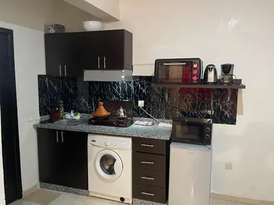 a kitchen with a washing machine and a washer at Appartement 24 4èm étage avec balcon ( POUR FAMILLE ) in Marrakech