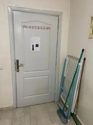 a white door in a room with a ladder at Appartement 25 4èm étage ( POUR FAMILLE ) in Marrakech