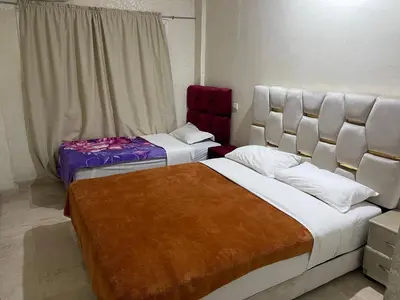 a bedroom with two beds and a window at Appartement 27 au 4ème étage ( POUR FAMILLE ) in Marrakech