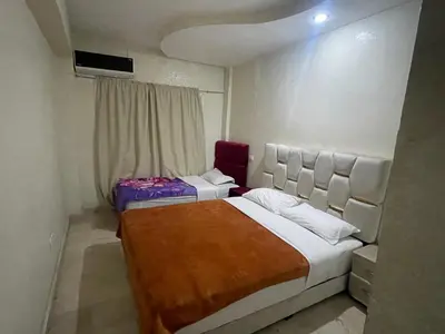 a bedroom with two beds and a window at Appartement 27 au 4ème étage ( POUR FAMILLE ) in Marrakech