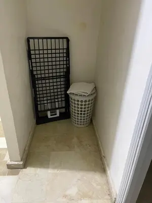 a corner of a room with a door and a basket at Appartement 28 au 4 éme étage avec balcon ( POUR FAMILLE ) in Marrakech