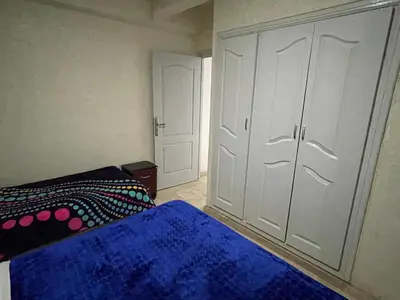 a bedroom with a bed and a large closet at Appartement 28 au 4 éme étage avec balcon ( POUR FAMILLE ) in Marrakech