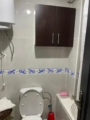 a small bathroom with a toilet and a cabinet at Appartement 30 au 5 ème étage avec balcon ( POUR FAMILLE ) in Marrakech