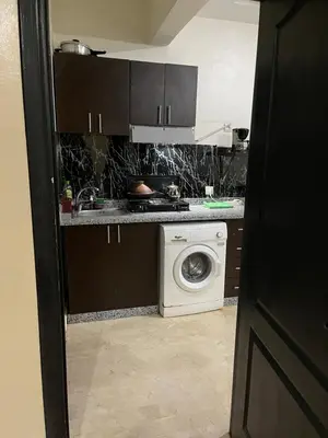 a kitchen with a washing machine and a washer at Appartement 30 au 5 ème étage avec balcon ( POUR FAMILLE ) in Marrakech
