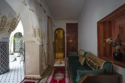 a living room with a couch and a window at Riad Maison Belbaraka in Marrakech