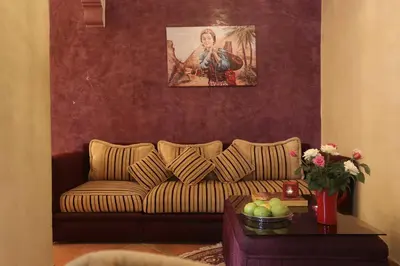 a living room with a couch and a table at Riad Mille Et Une Nuits in Marrakech