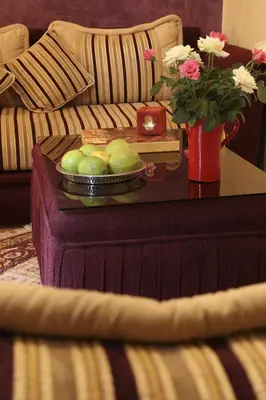 a coffee table with a tray of apples on a table at Riad Mille Et Une Nuits in Marrakech