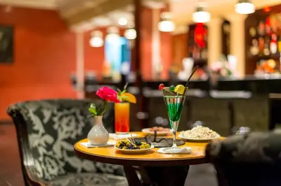 a table with plates of food and a drink on it at Kennedy Hospitality Resort in Marrakech