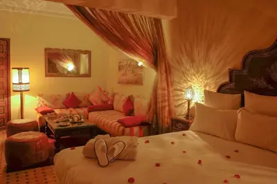 a hotel room with a bed and a couch at Riad Marrakech By Hivernage in Marrakech