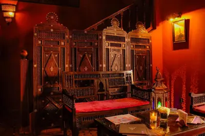 a room with a bench and a table with a fireplace at Riad Marrakech By Hivernage in Marrakech