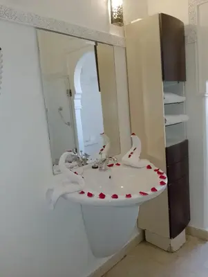 a bathroom with a white sink and a mirror at Riad Marrakech By Hivernage in Marrakech