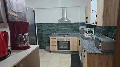 a kitchen with a sink and a stove top oven at Bitty Apartment in Marrakech