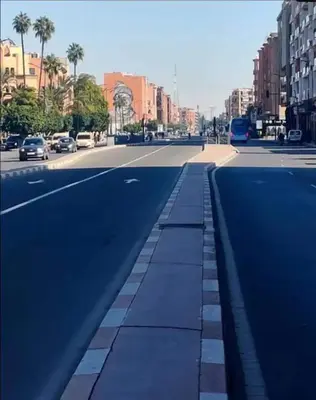 an empty city street with cars on the road at Bitty Apartment in Marrakech