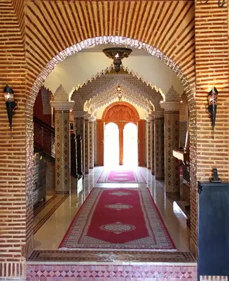 an archway in a building with a rug on the floor at Palais Dar Ouladna in Marrakech