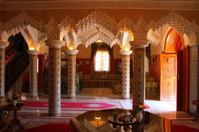 a large room with columns and a couch in a building at Palais Dar Ouladna in Marrakech