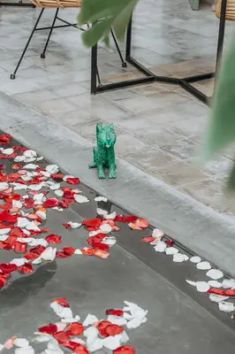 a green figurine in the middle of a street with red and whiteetti at Riad Villa Wengé & Spa in Marrakech