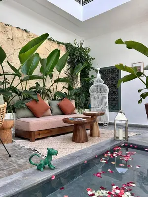a living room with a couch and a table at Riad Villa Wengé & Spa in Marrakech