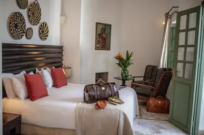 a bedroom with a bed with a purse on it at Riad Palais Calipau in Marrakech