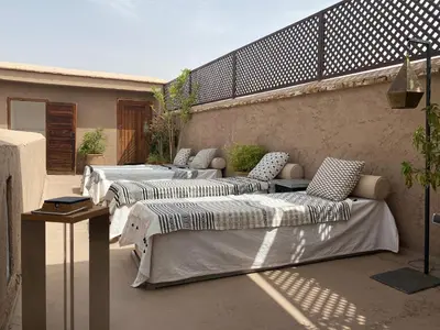 a group of beds sitting on a patio at Riad Djebel in Marrakech