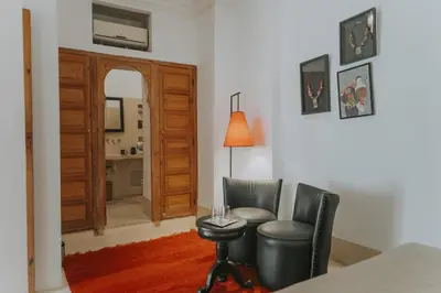 a living room with two chairs and a table at Riad Djebel in Marrakech