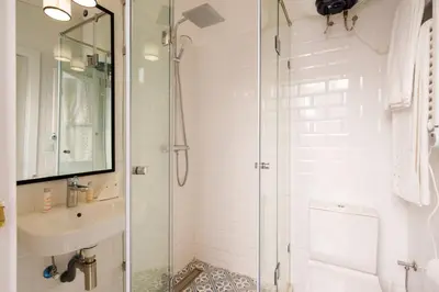 a bathroom with a glass shower and a sink at Riad 2 chambres & Petit Déjeuner - Wifi - Top Location Médina in Marrakech